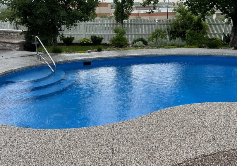 A pool with steps and stairs in the middle of it.